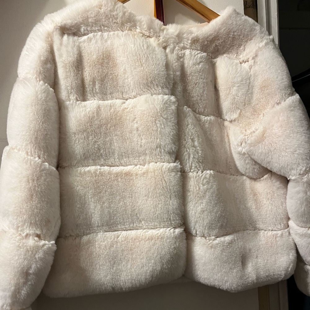 White faux fur cropped jacket.